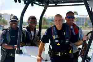 four police officers on a boat